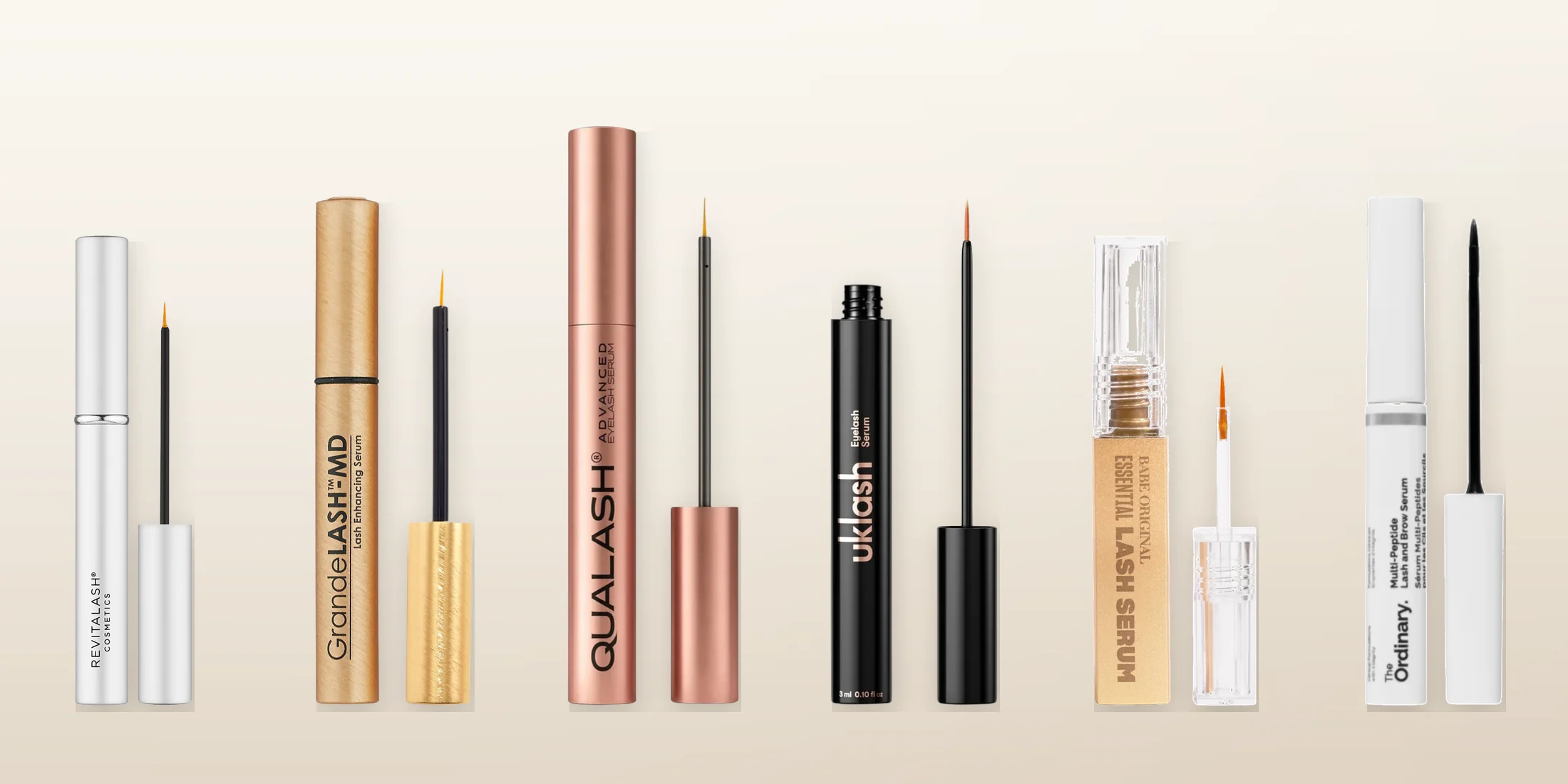 Six eyelash growth serums tested for the 2026 ranking, lined up on a warm background